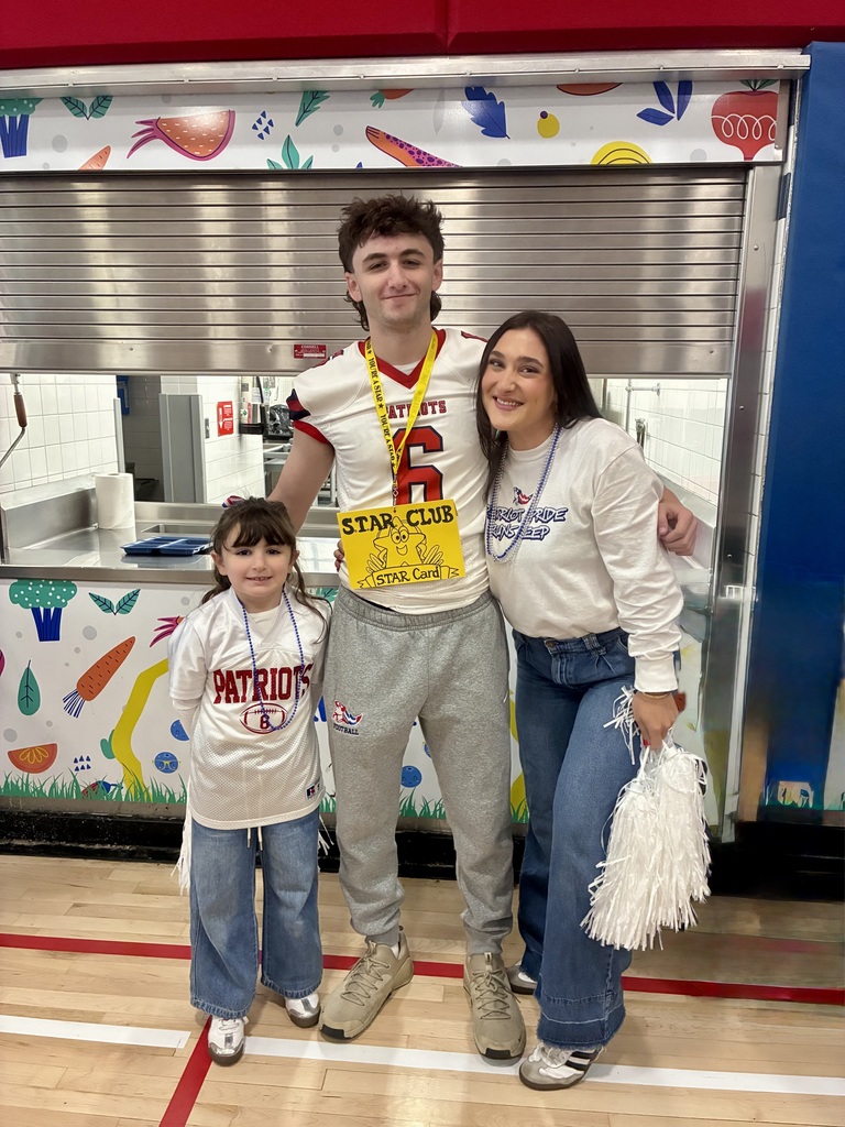 A football player wearing a yellow star card with a student and a teacher.