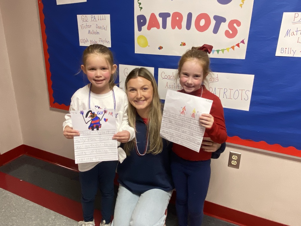 A group of students in front of a bulletin board.