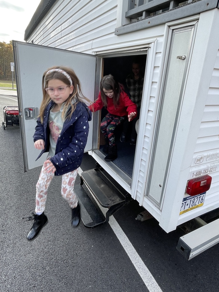 Students in a smoke house filled with smoke.