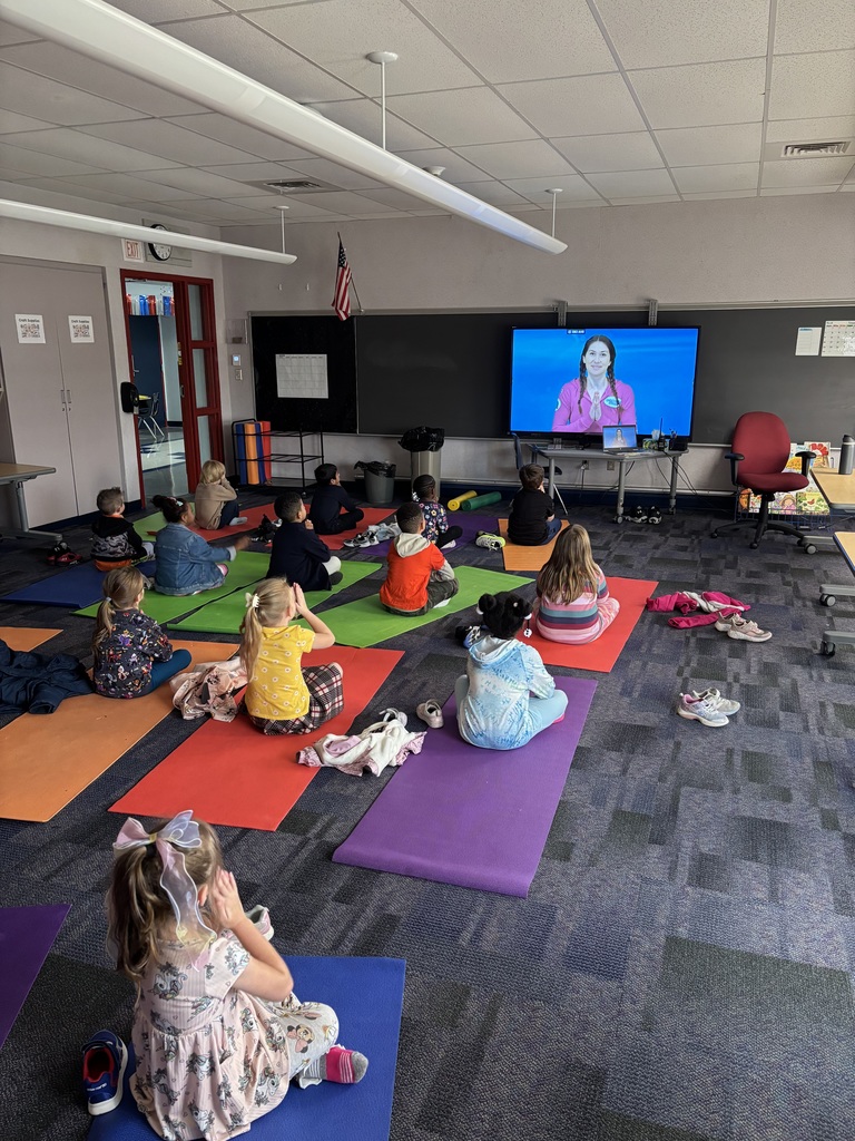 Kids doing yoga in stem lab.