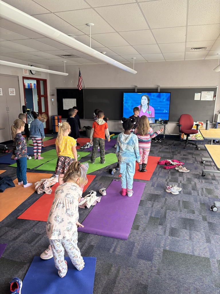 Kids doing yoga in stem lab.