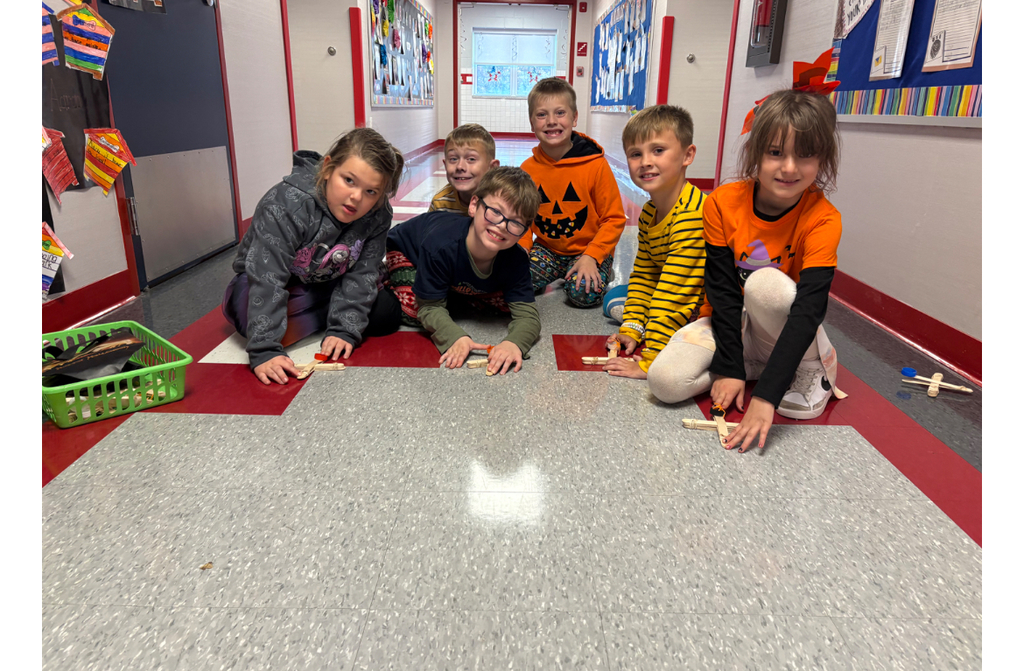 Students participating in a stem challenge.