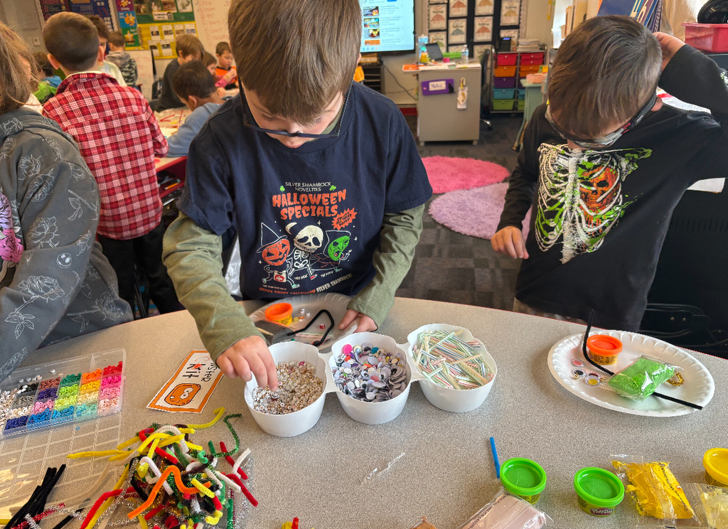 Students participating in a stem challenge.
