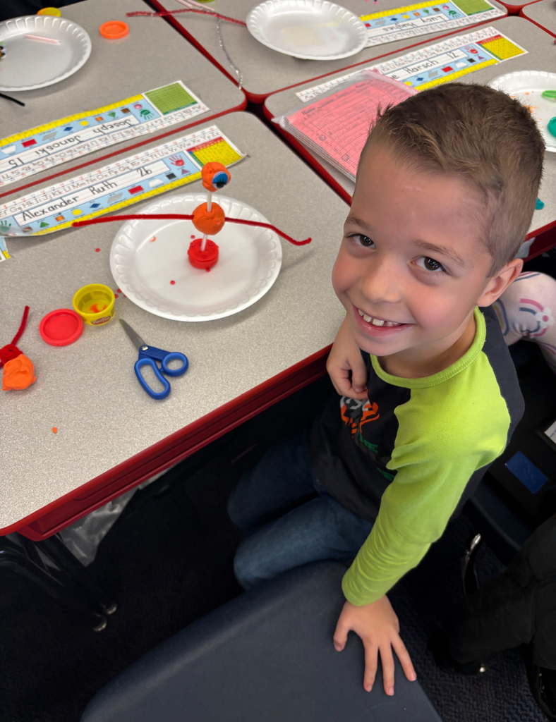 Students participating in a stem challenge.