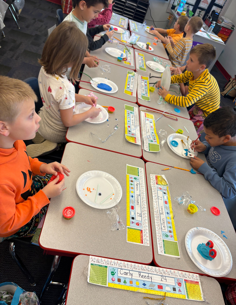 Students participating in a stem challenge.