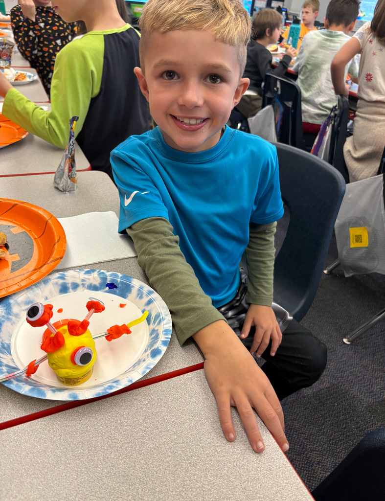 Students participating in a stem challenge.