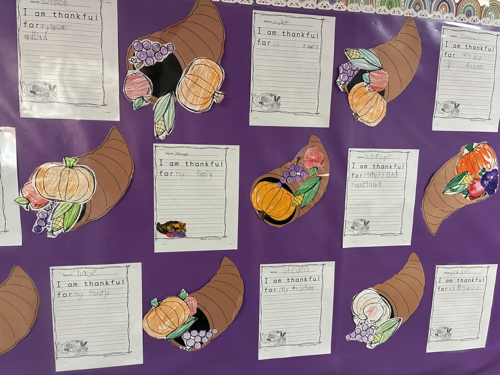 A bulletin board with student writing pieces displayed.