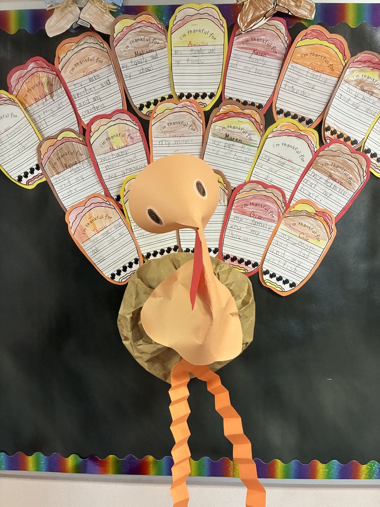 A bulletin board with student writing pieces displayed.