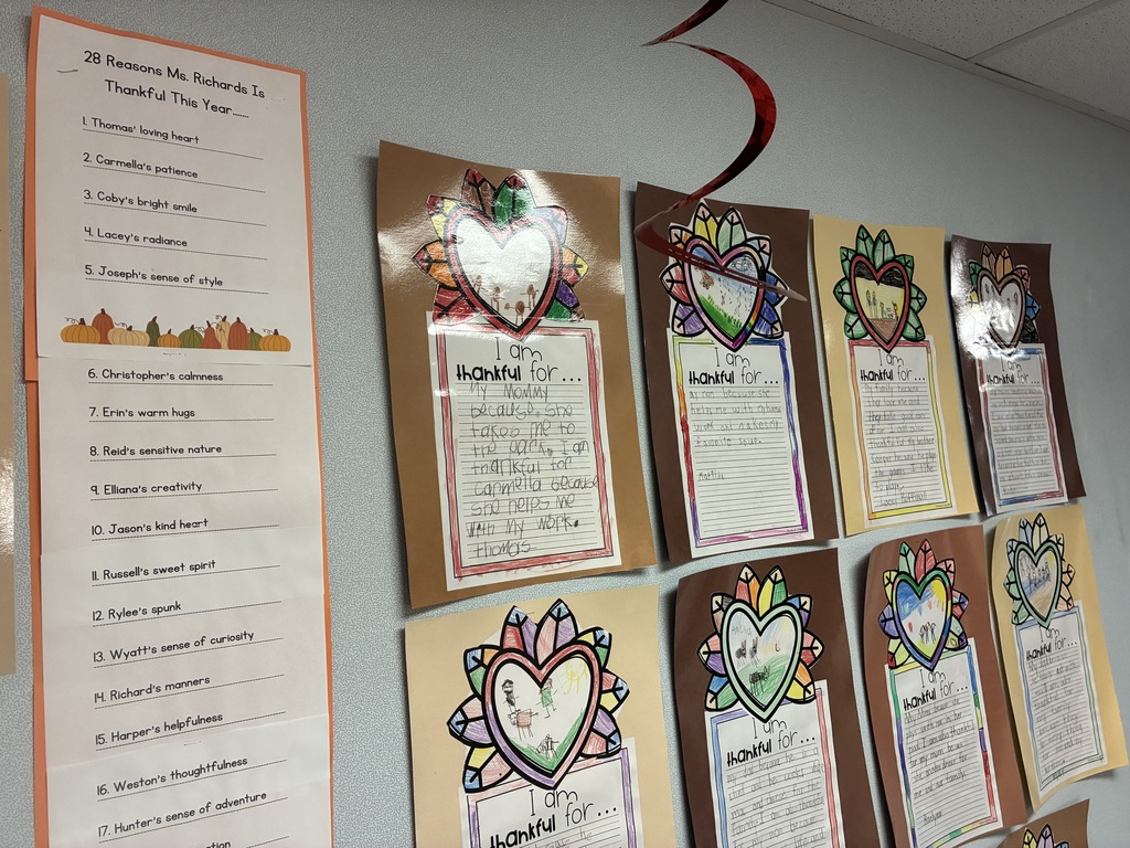 A bulletin board with student writing pieces displayed.