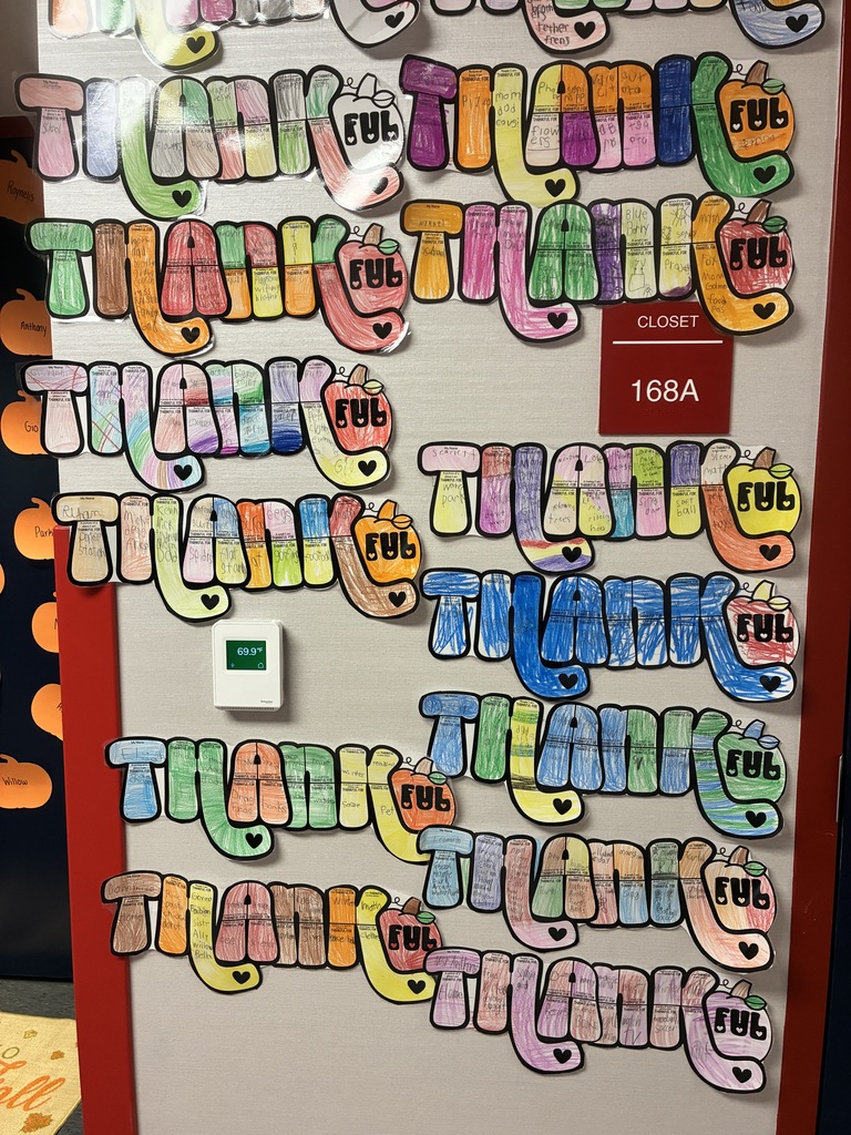 A bulletin board with student writing pieces displayed.