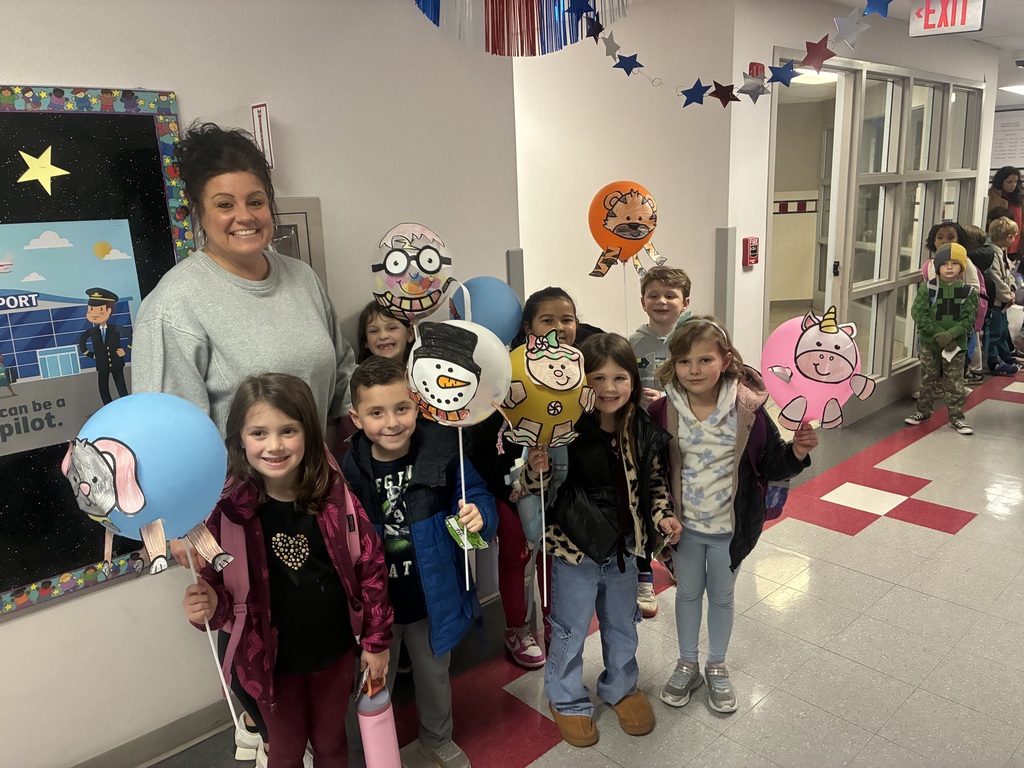 Kids holding decorated balloons. .
