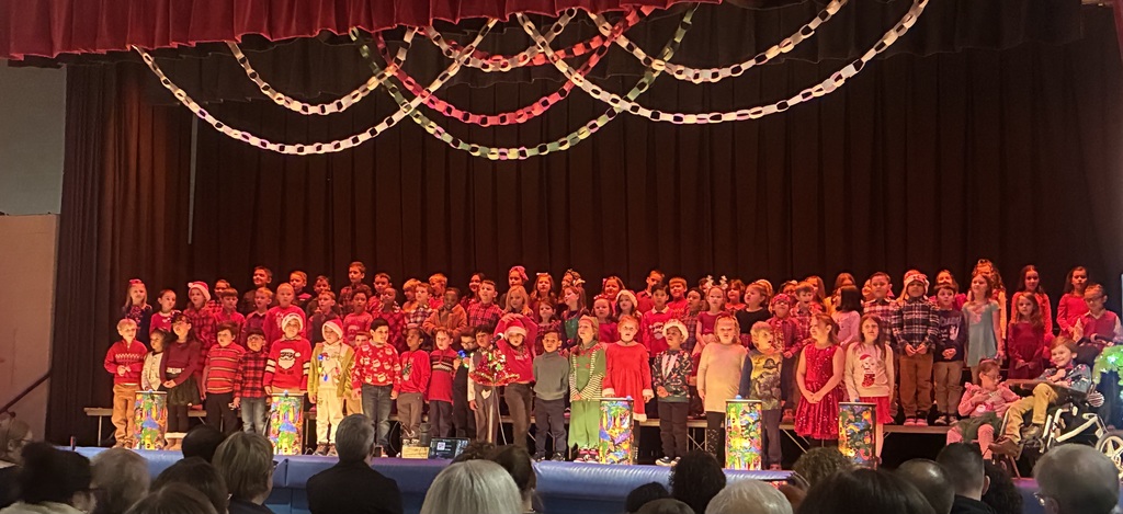 A group of students on a stage in a school gym. 