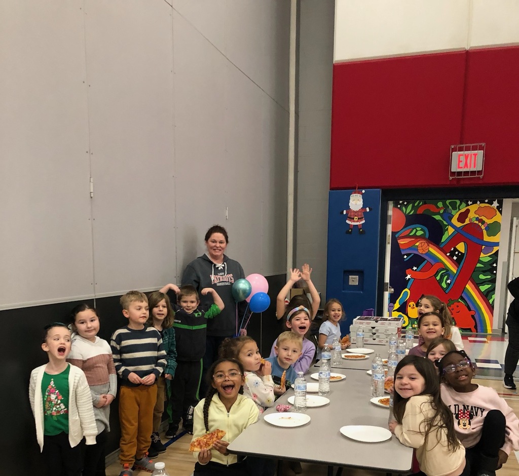 Students at a pizza party in the cafeteria . 