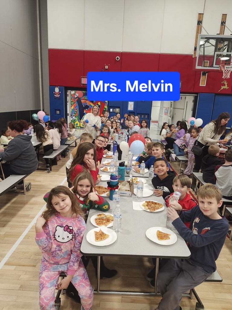 Students at a pizza party in the cafeteria . 