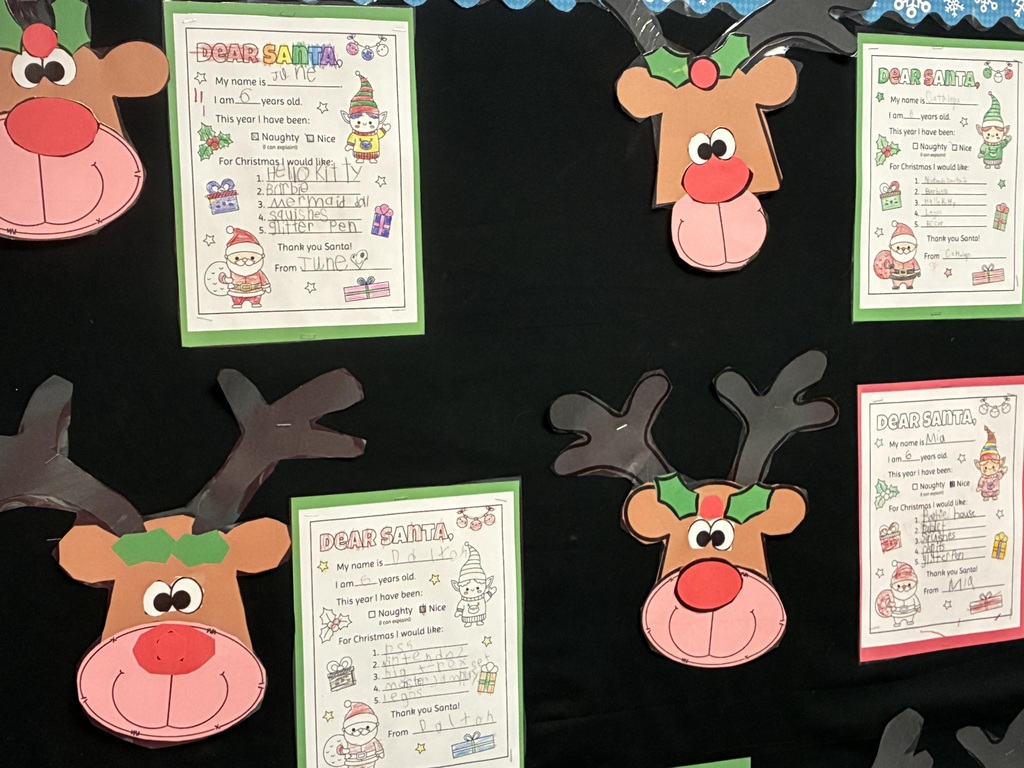 Student written letters to santa displayed on a bulletin board. 