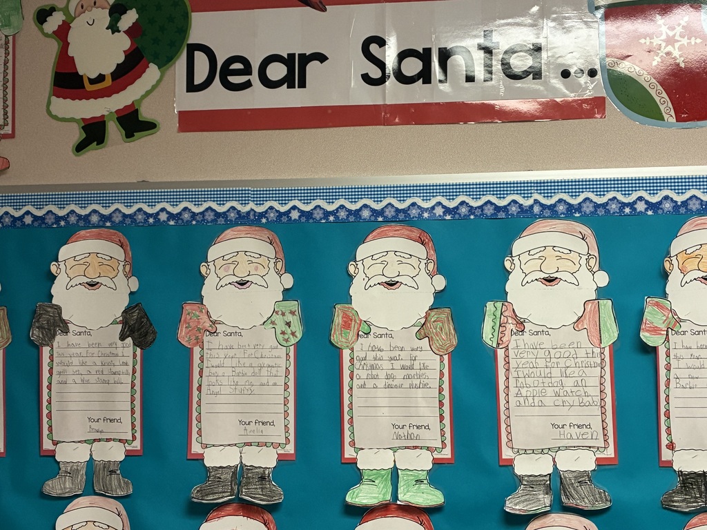 Student written letters to santa displayed on a bulletin board. 