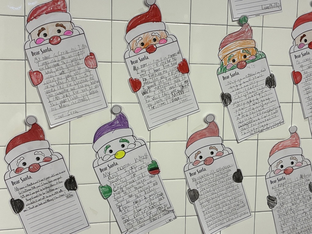 Student written letters to santa displayed on a bulletin board. 