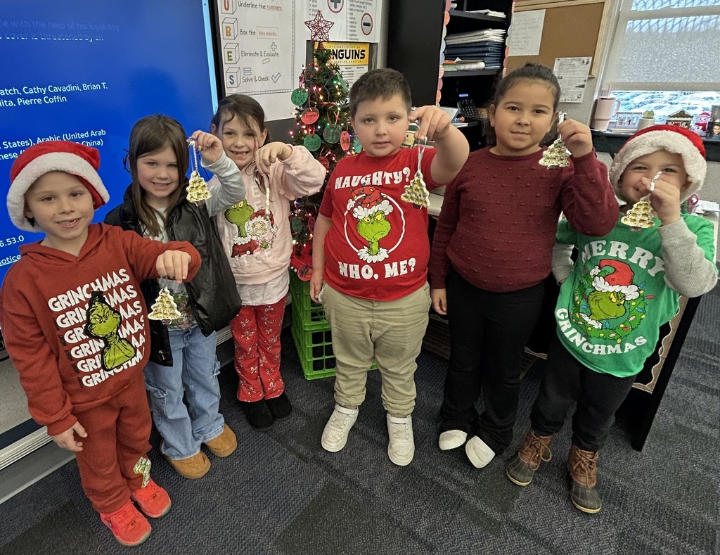 Students holding homemade ornaments. 