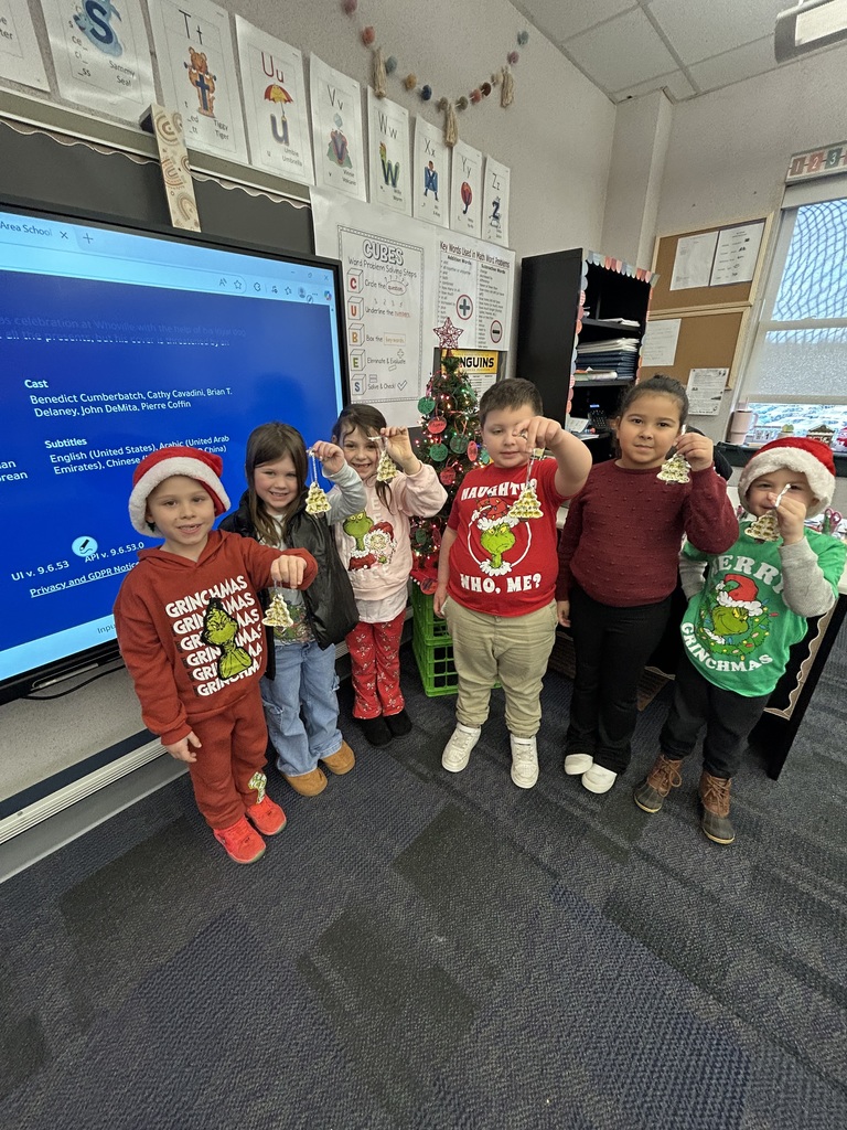 Students holding homemade ornaments. 