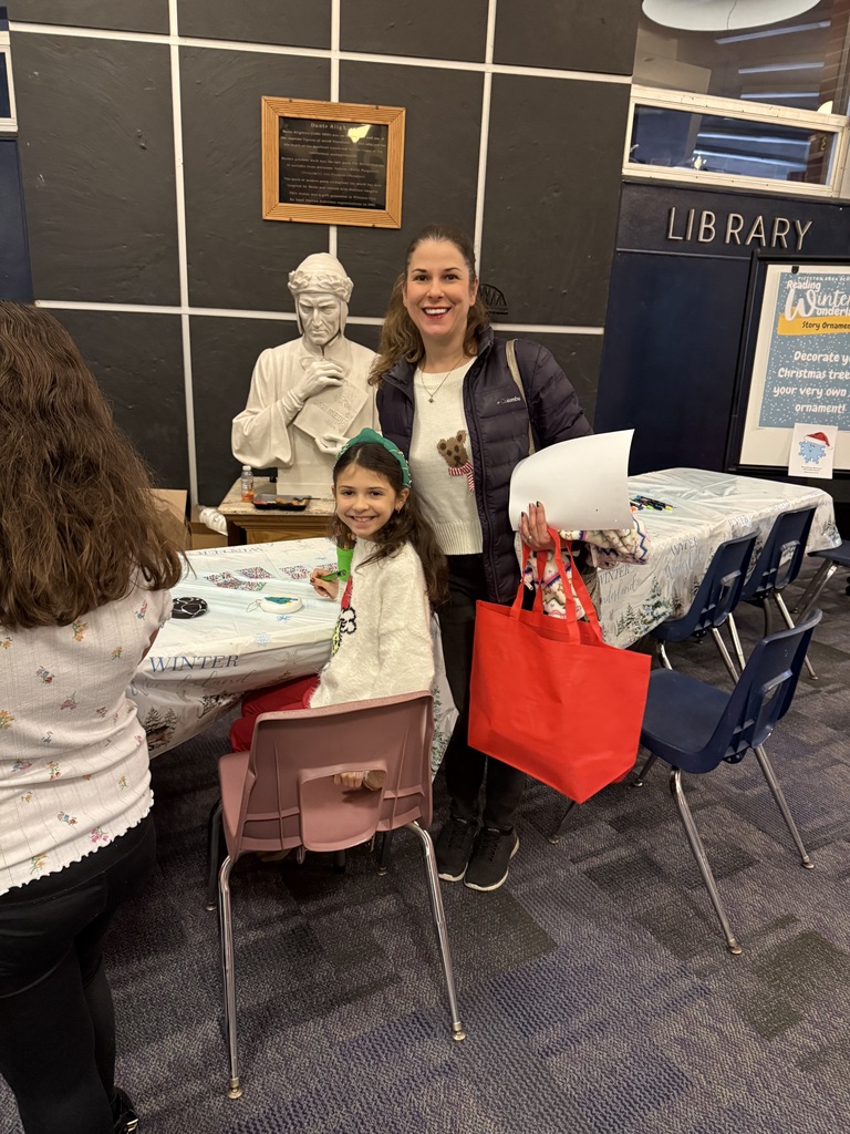 A mom and daughter smiling at the camera.