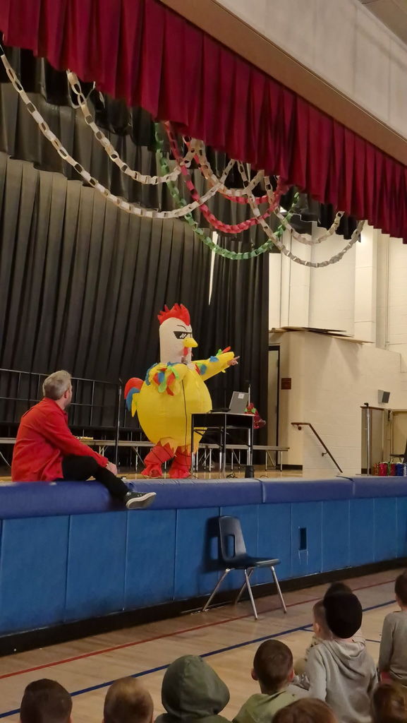 People on a stage in inflatable holiday costumes 