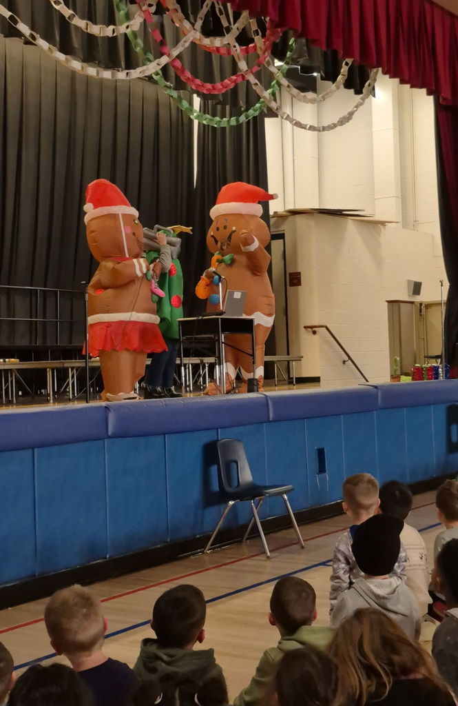 People on a stage in inflatable holiday costumes 