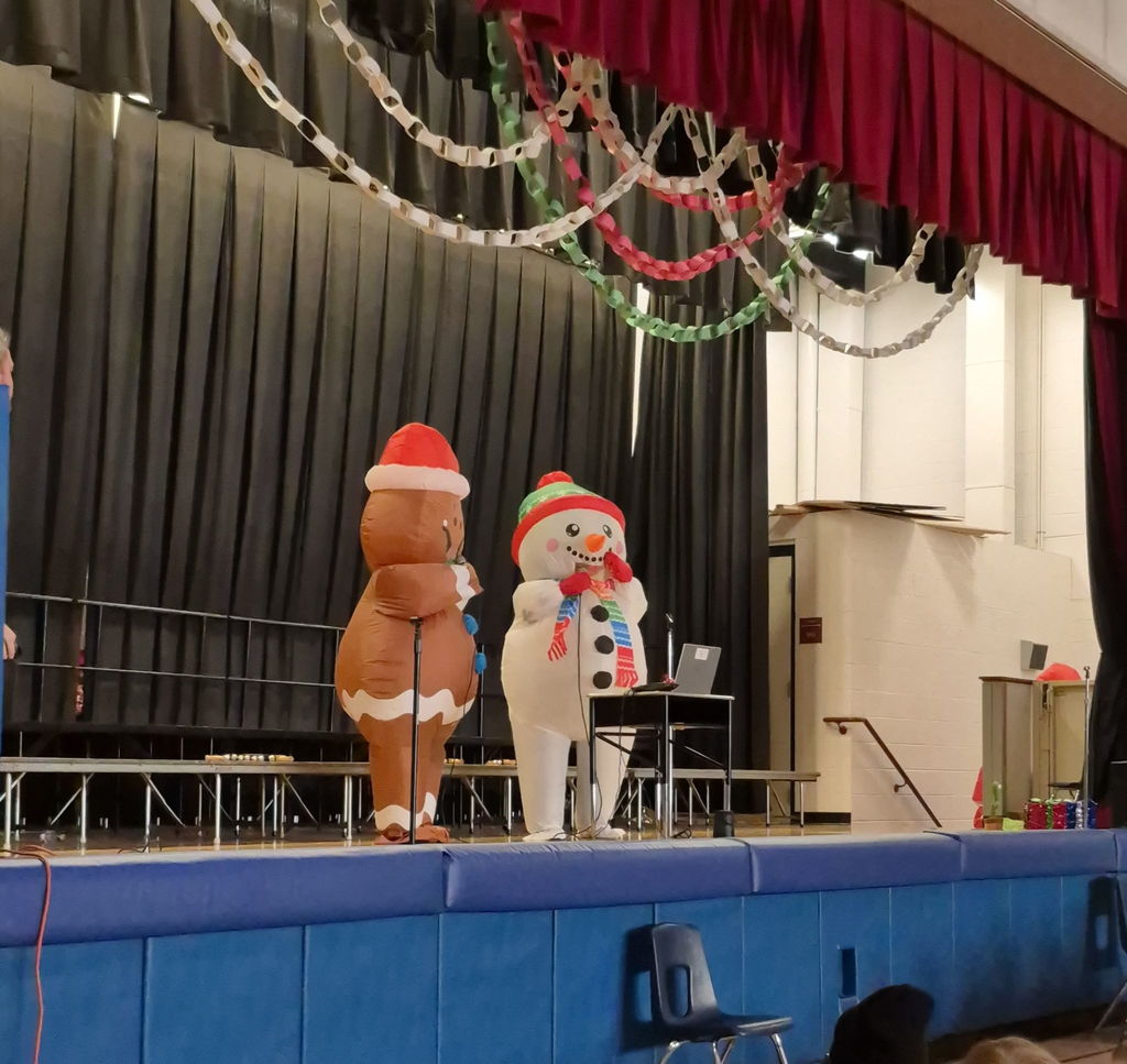 People on a stage in inflatable holiday costumes 
