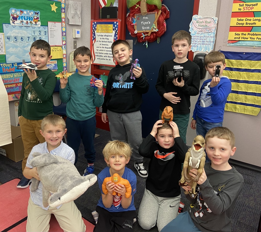 Students holding show and tell items in agroup