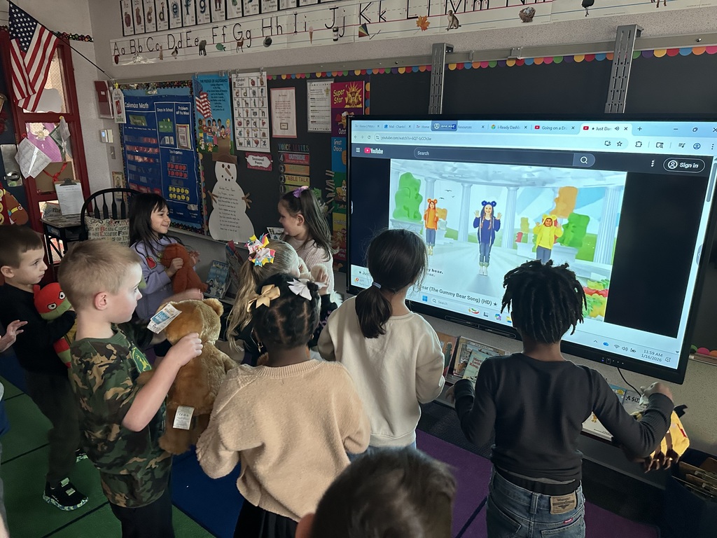 Kindergarten students with stuffed teddy bears 