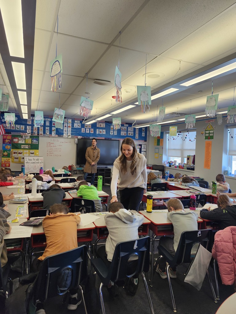 Students in a classroom playing heads up 7 up.