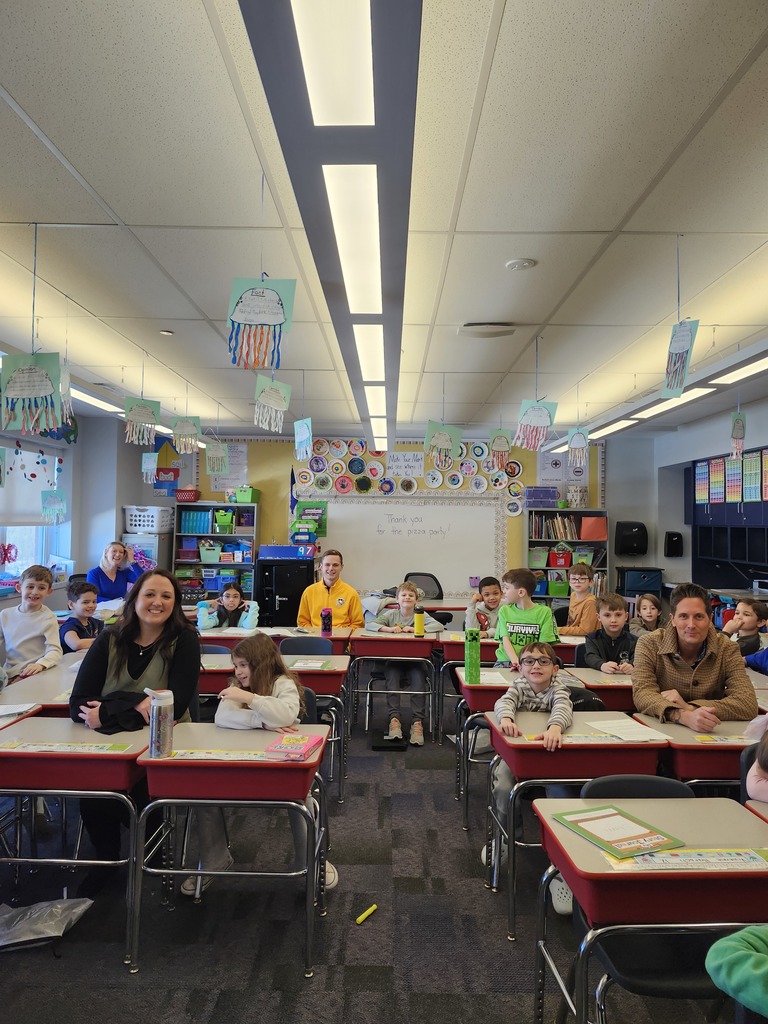 Students in a classroom playing heads up 7 up.