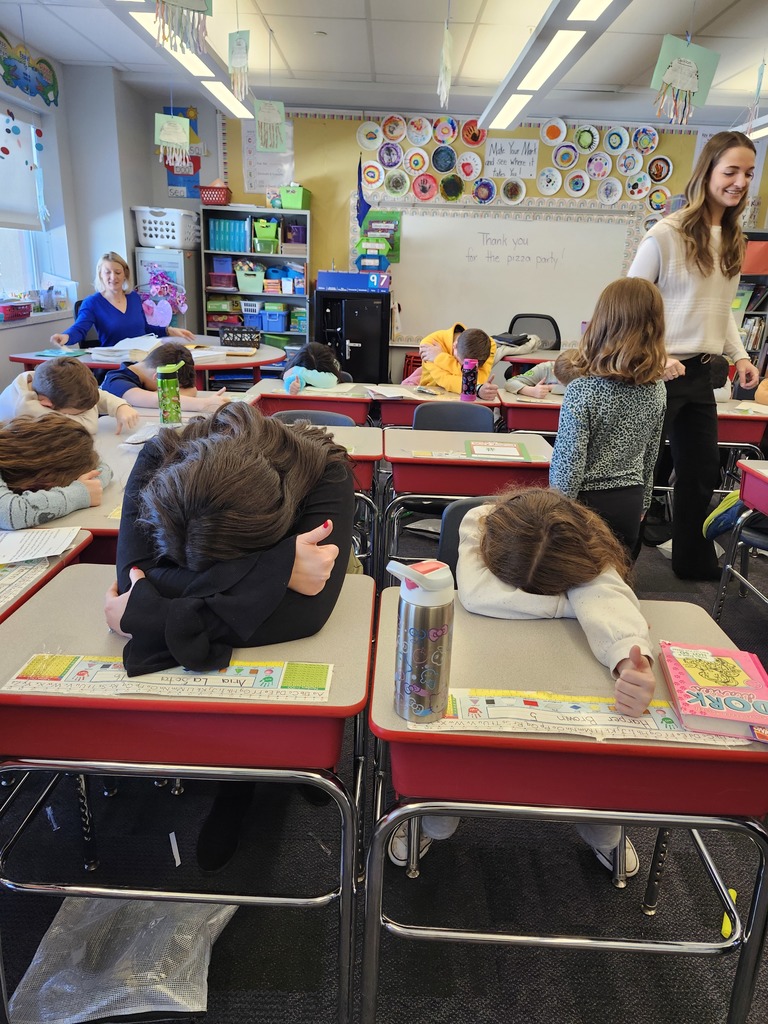 Students in a classroom playing heads up 7 up.