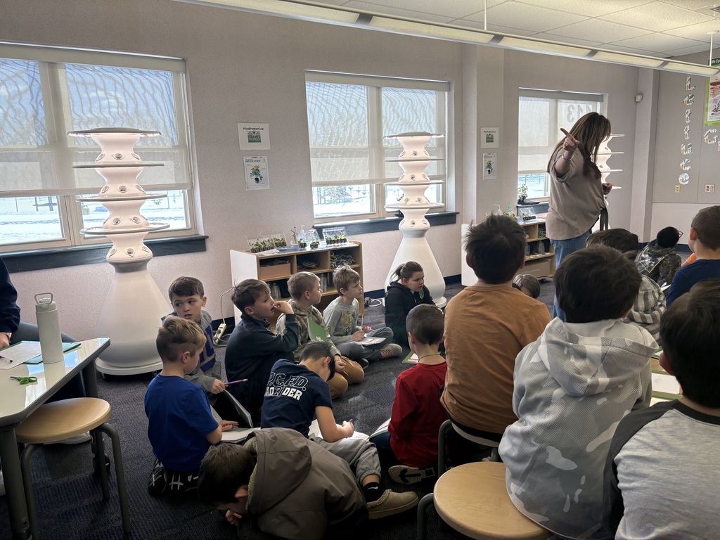 A teacher presenting about hydroponic farm stands.