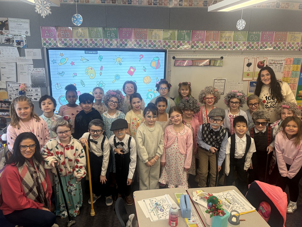 A group of students in a group with dressed like they’re 100.