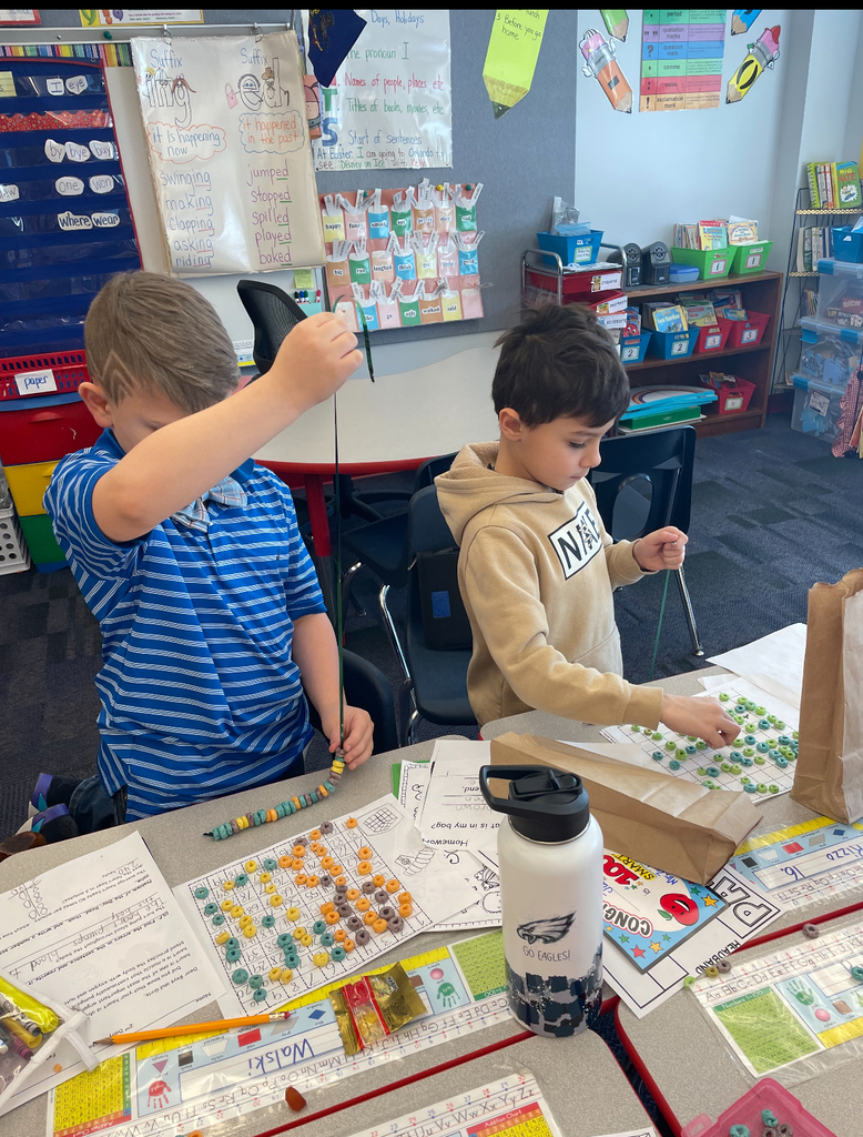 Students making 100 fruit loop necklaces.