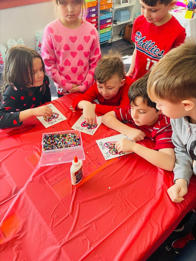 Elementary students with valentines crafts