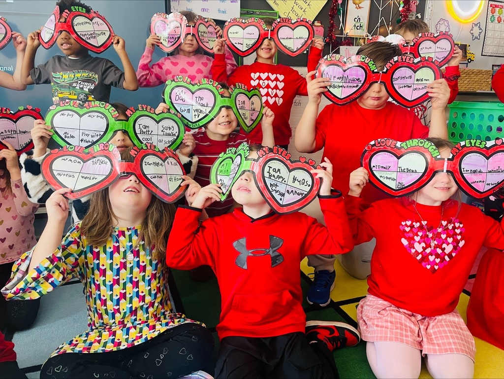 Elementary students with valentines crafts