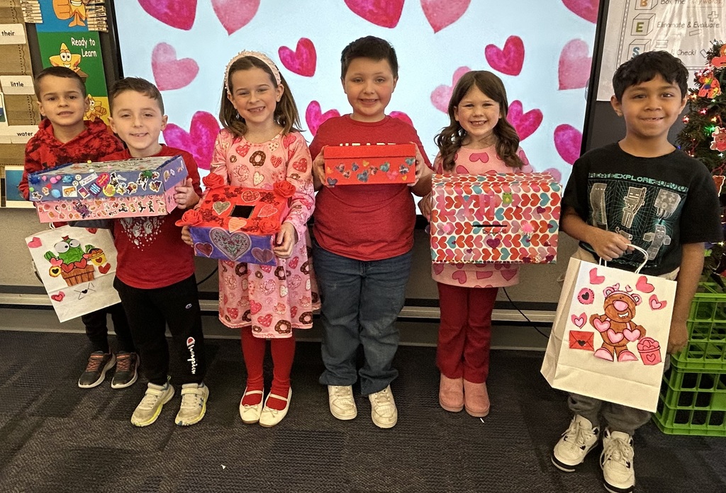 Elementary students with valentines crafts