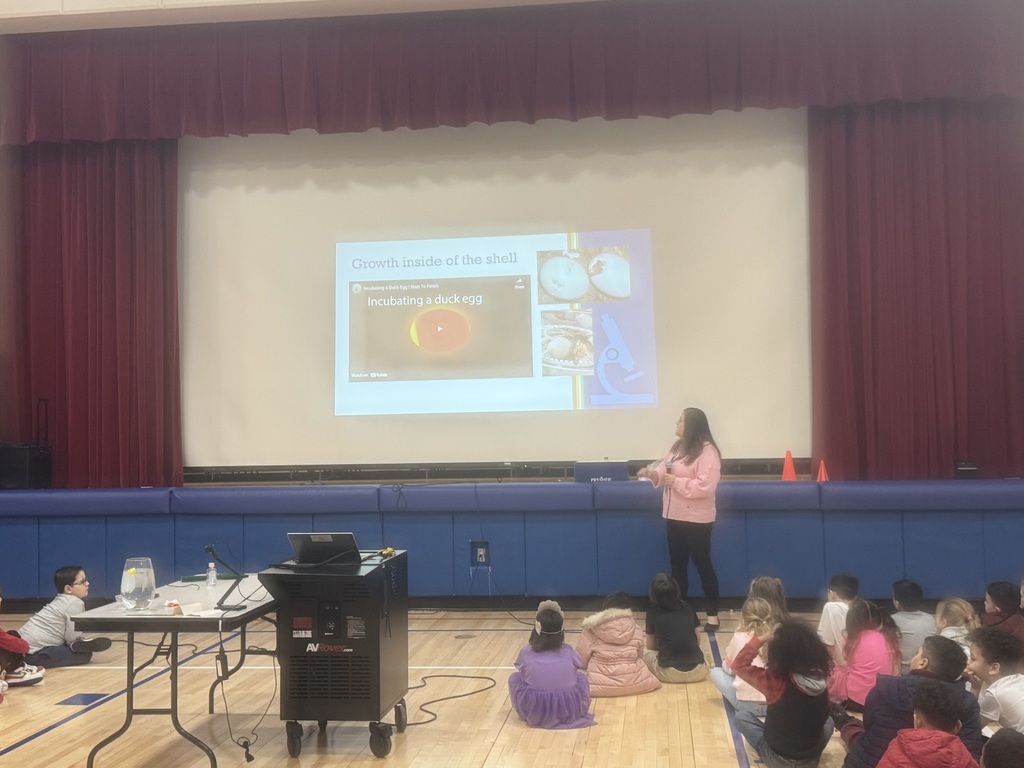 Kids in a gym with a duck presentation.