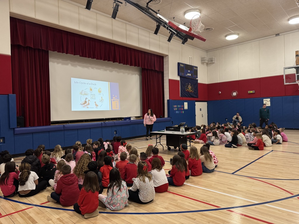 Kids in a gym with a duck presentation.