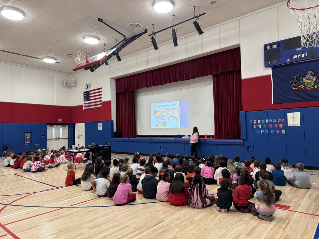Kids in a gym with a duck presentation.