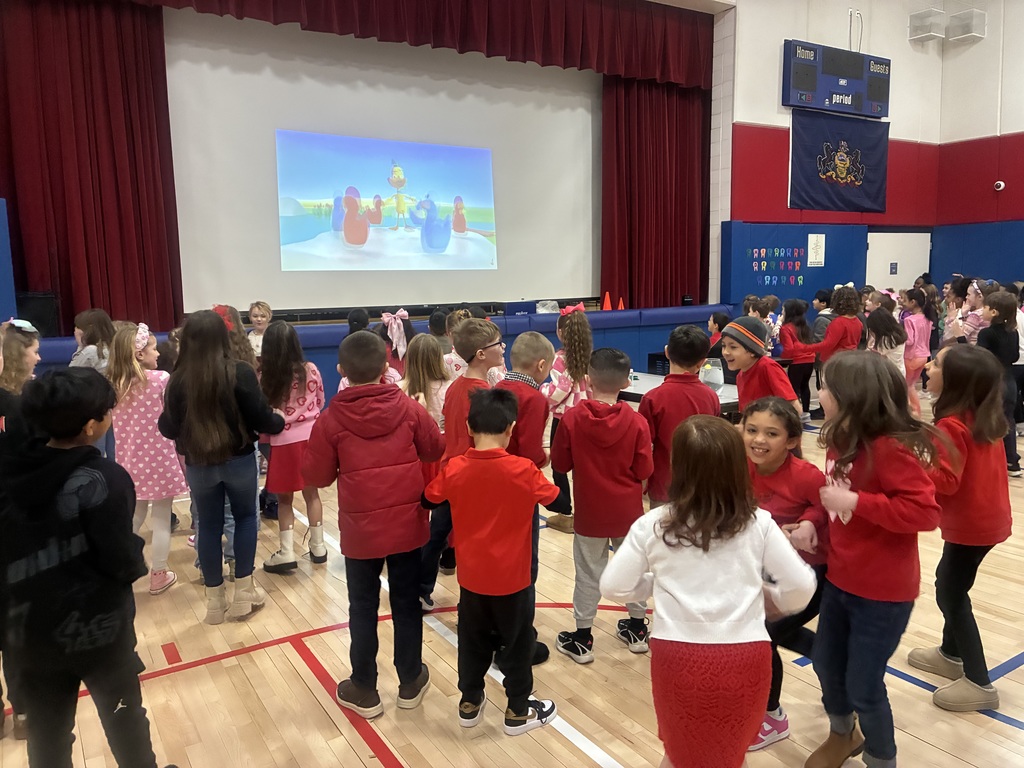 Kids in a gym with a duck presentation.