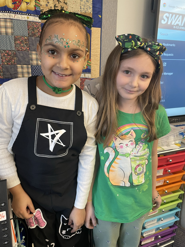 Two girls dressed in green