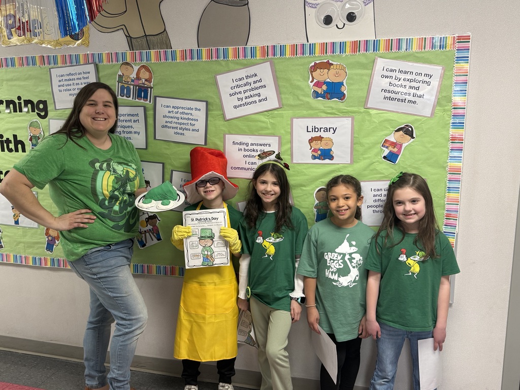 A teacher and students dressed up in green.