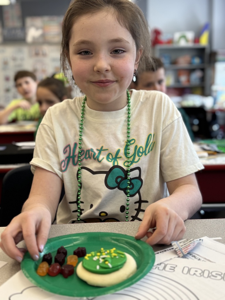 A student with a plate of green food.