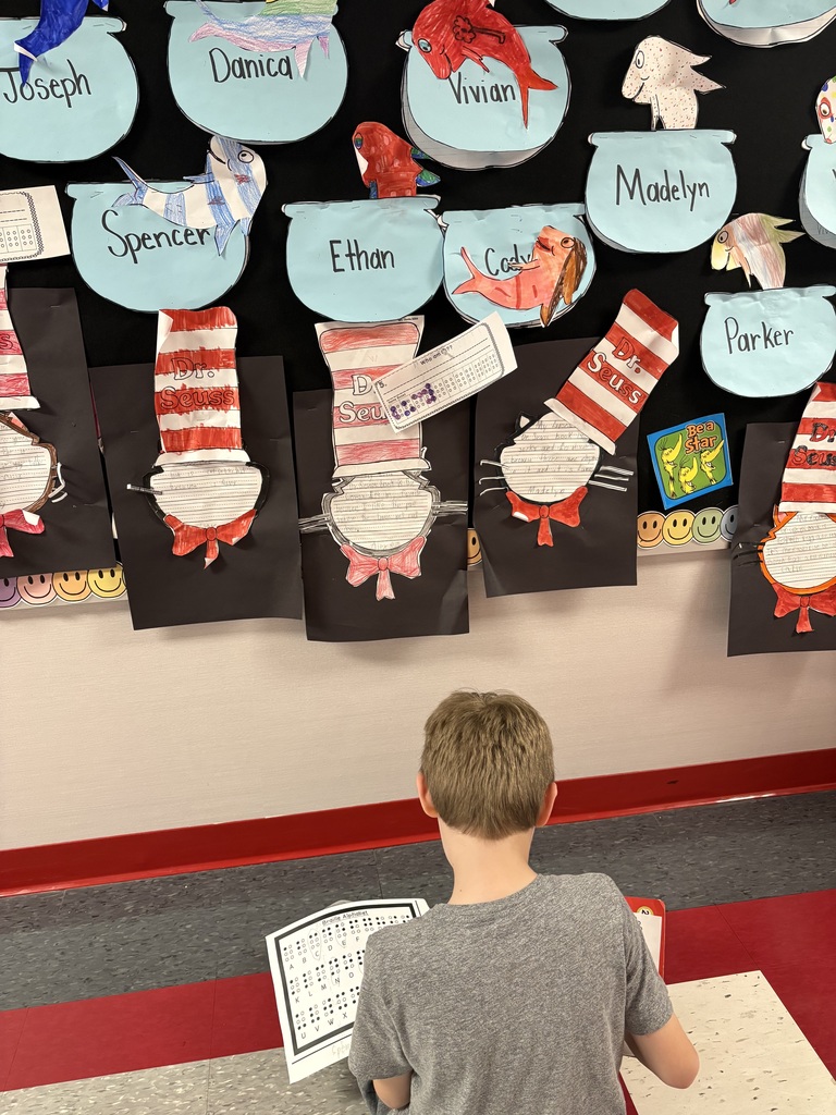 Students exploring braille in a school hallway