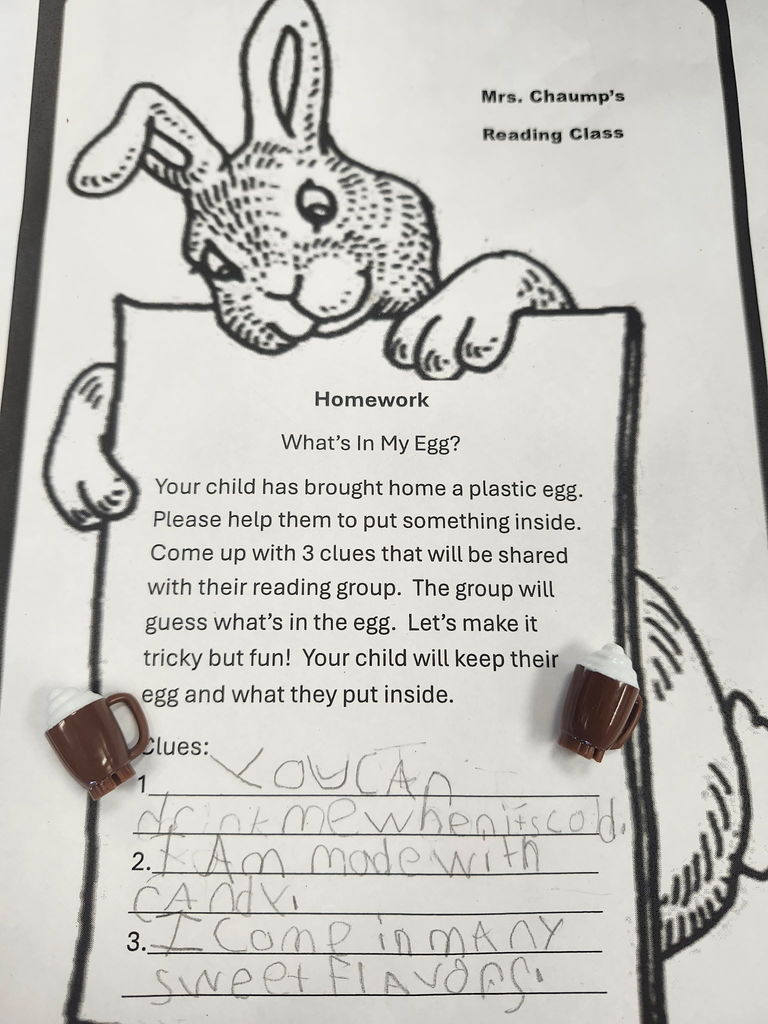 A plastic egg with student writing of three clues of what is inside. 