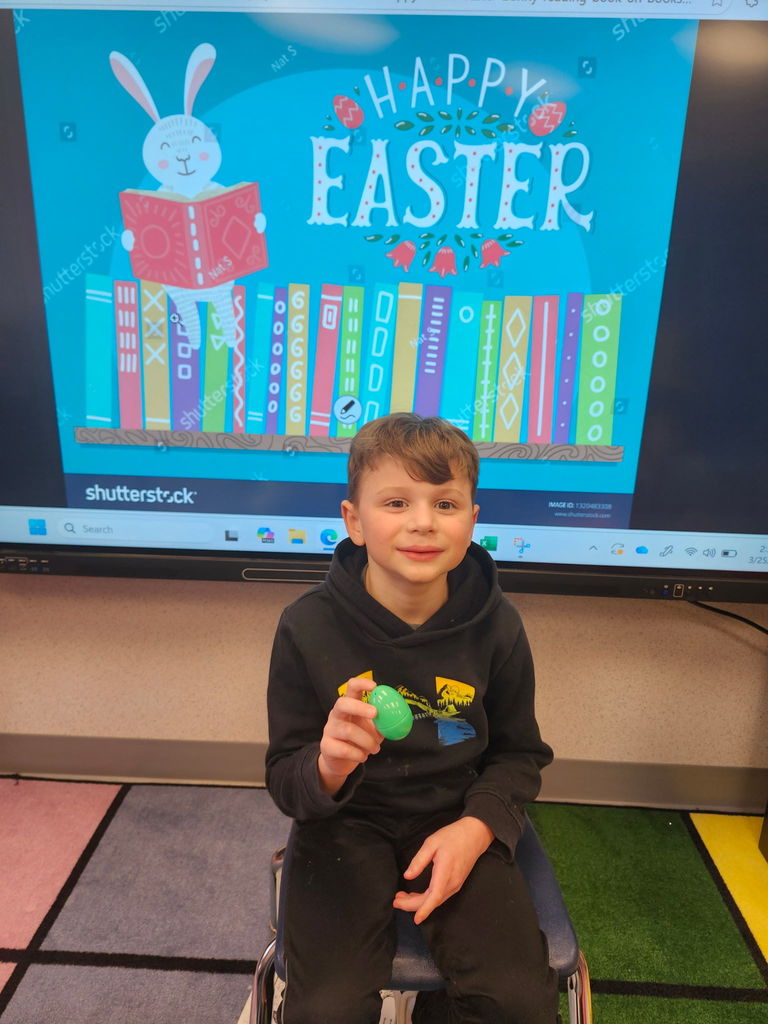 A student holding a plastic easter egg. 
