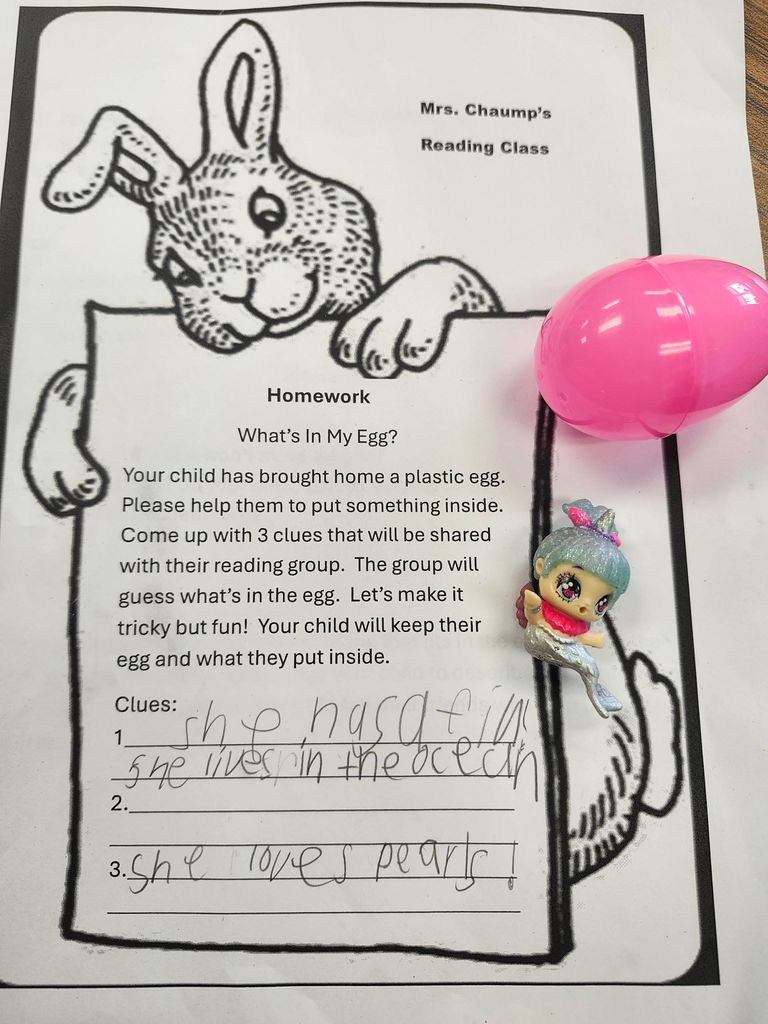 A plastic egg with student writing of three clues of what is inside. 