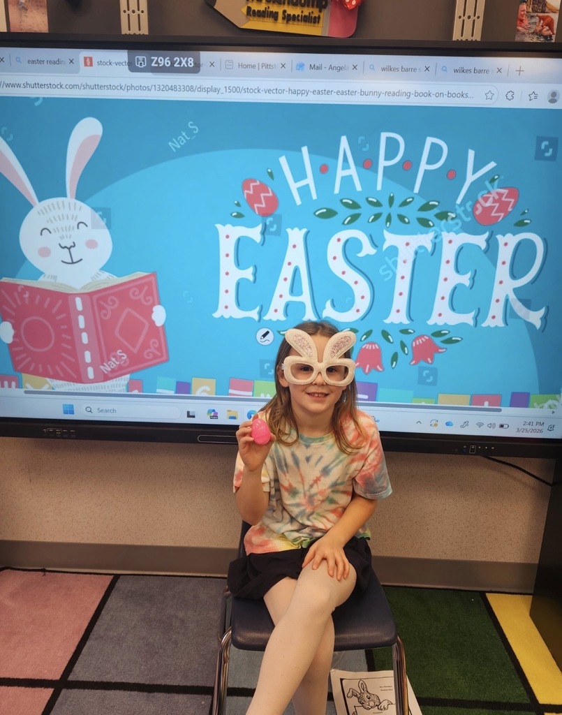 A student holding a plastic easter egg wearing white rabbit glasses